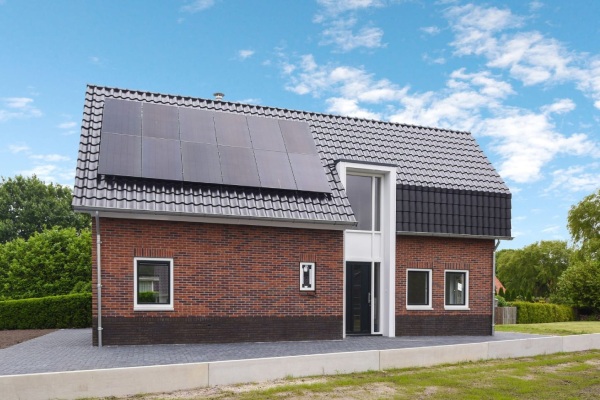 Kies je voor ons bouwbedrijf in Coevorden, dan kies je voor hoge kwaliteit. Nieuwbouwwoning met zonnepanelen vanaf zijkant vastgelegd.